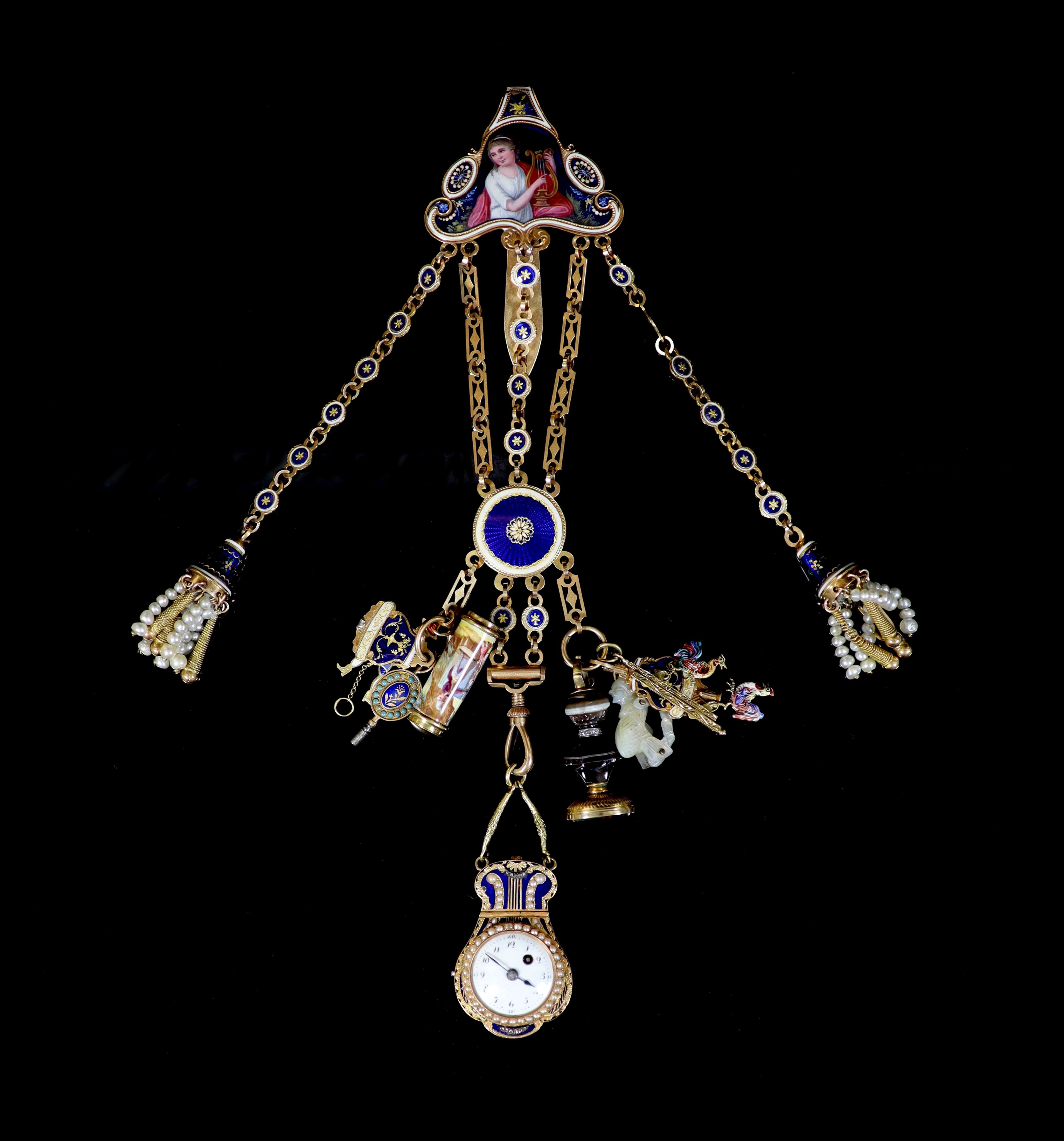 An early 19th century French or Swiss gold and enamel chatelaine, hung with eleven assorted accoutrements